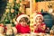 Little boy and cute little girl with santa hat preparing cookies in the kitchen at home. Santa cook. Happy children bake