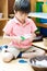 Little boy cutting paper of montessori educational
