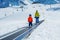 Little boy and a dad go up on the ski moving walkway