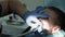 A little boy with damaged baby teeth having a treatment in the dentistry. close-up.