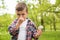 Little boy with dandelions suffering from seasonal allergy outdoors