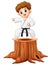 Little boy doing karate on tree stump