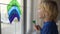 Little boy drawing on window rainbow while coronavirus quarantine. Rainbow sign is symbol of hope