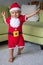 A little Boy Dressed in a Santa Outfit