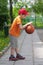 Little boy dribbling basketball sideview