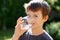 Little boy drink water in nature