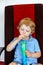 Little boy drinking colorful frozen slush ice