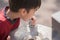 Little boy drinking public water in the park