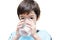 Little boy drinks water from a glass