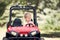 Little boy drive a mini electric car in park