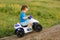 Little boy driving off road toy quad