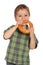 Little boy eating bagel