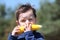 Little boy eating fresh boiled corn