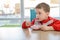 The little boy eating fruit yoghurt in a bowl