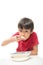 Little boy eating instant noodle on white background