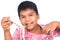 little boy eating macaroni on white background