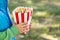 Little boy eating popcorn. Little boy grabbing popcorn from the bucket while