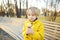 Little boy eating tasty ice cream outdoors during family stroll. Child have a snack on the go. Gelato is loved delicacy of kids.