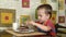 Little boy eats cake using a spoon. A happy child loves sweetness.