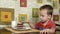 Little boy eats cake using a spoon. A happy child loves sweetness.