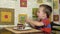 Little boy eats cake using a spoon. A happy child loves sweetness.