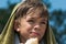 A little boy eats a sandwich after swimming