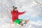 Little boy enjoying a sleigh ride. Child sledding. Toddler kid riding a sledge. Children play outdoors in snow. Kids sled in the