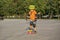 A little boy enjoys a yellow cruiser penny plastboard
