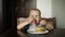 Little boy in fast food cafe eats burger. little kid eating burger.