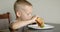 Little boy in fast food cafe eats burger. little kid eating burger.