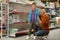 Little boy and father near shelves with school stationery