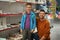 Little boy and father near shelves with school stationery