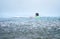 Little boy first step surfer try to stand up on board under tropical rain