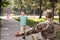 Little boy with flag of USA running towards his father in military uniform outdoors. Family reunion