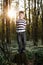 Little boy in forest on flowers field