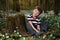 Little boy in forest on flowers field