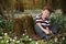 Little boy in forest on flowers field