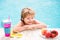 Little boy with fresh cocktail and fruits on watter pool in the summer day. Kid in swimming pool relax and swim in blue