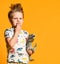 Little boy with a funny, disheveled hair holds the toy plastic dinosaur as a portrait.