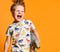 Little boy with a funny, disheveled hair holds the toy plastic dinosaur as a portrait.