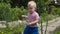 A little boy in the garden to learn to use garden equipment