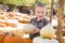 Little Boy Gathering His Pumpkins at a Pumpkin Patch