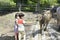 Little boy and girl feeding buffalo at animal farm