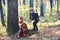 Little boy and girl friends camping in woods. Children play in autumn forest. Childhood and child friendship, love and