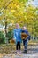 Little boy and girl gathering autumn leaves