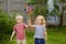 Little boy and girl having fun during walk. Happy child with pinwheel