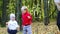 Little boy and girl, mother have fun in autumn