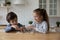 Little boy and girl playing wooden educational game, checkers