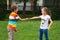 Little boy and girl shaking hands in park, outdoor