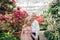 Little boy and girl are walking in a blooming garden